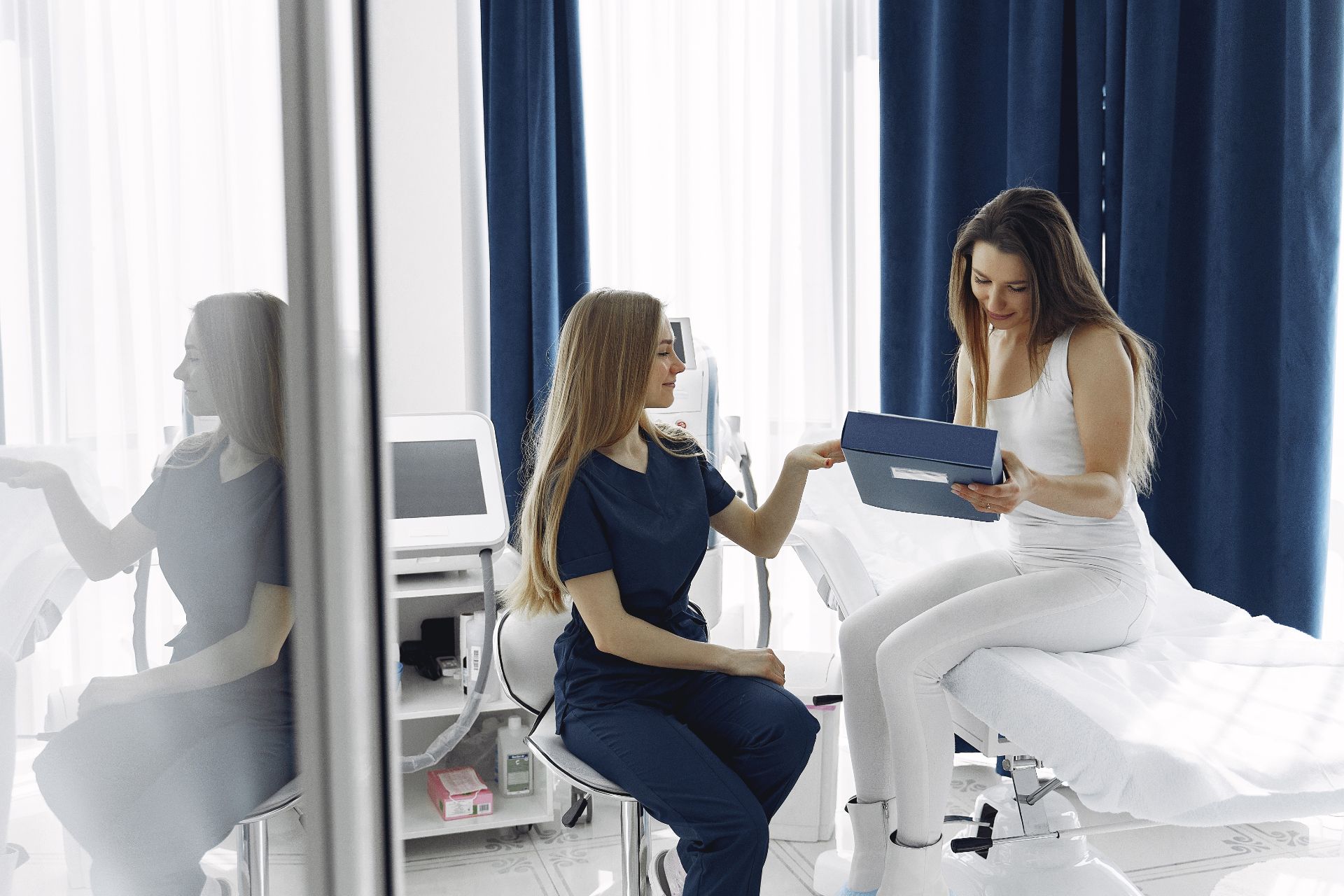 Client sitting with aesthetician consulting