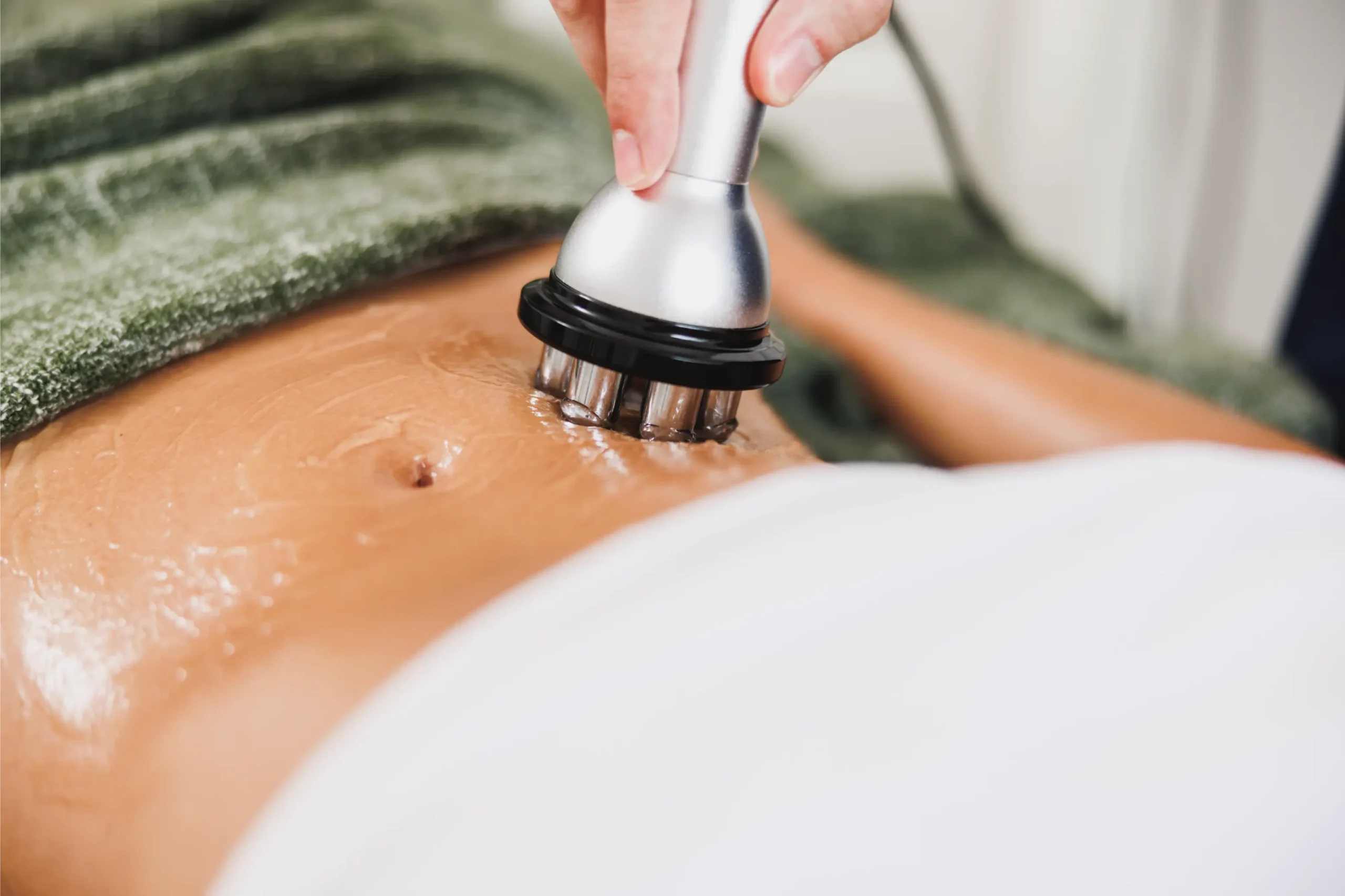 Client's stomach with radio frequency machine applied to belly area