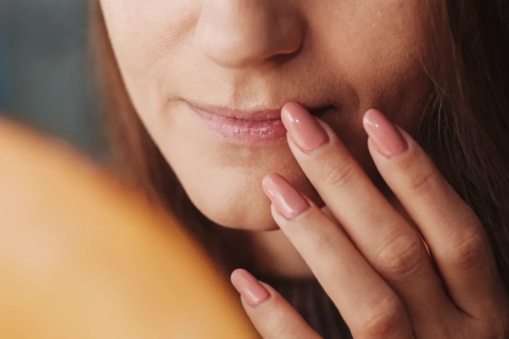 Woman touching dry thinning lips