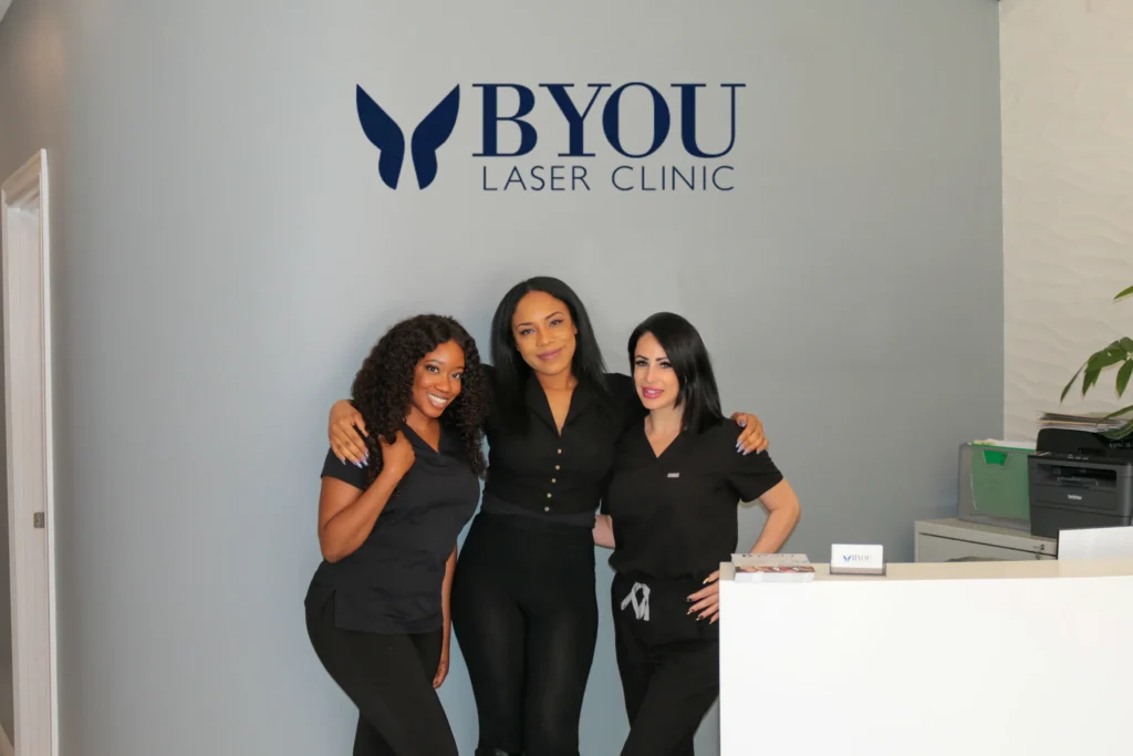 Workers standing together infront of BYou sign