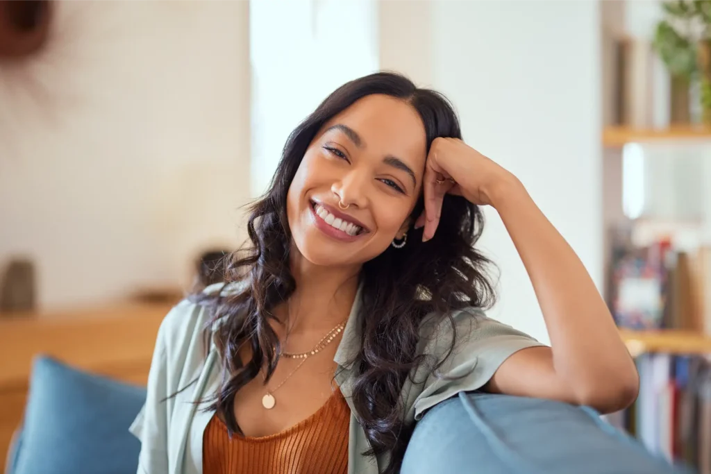 Woman sitting on couch smiling