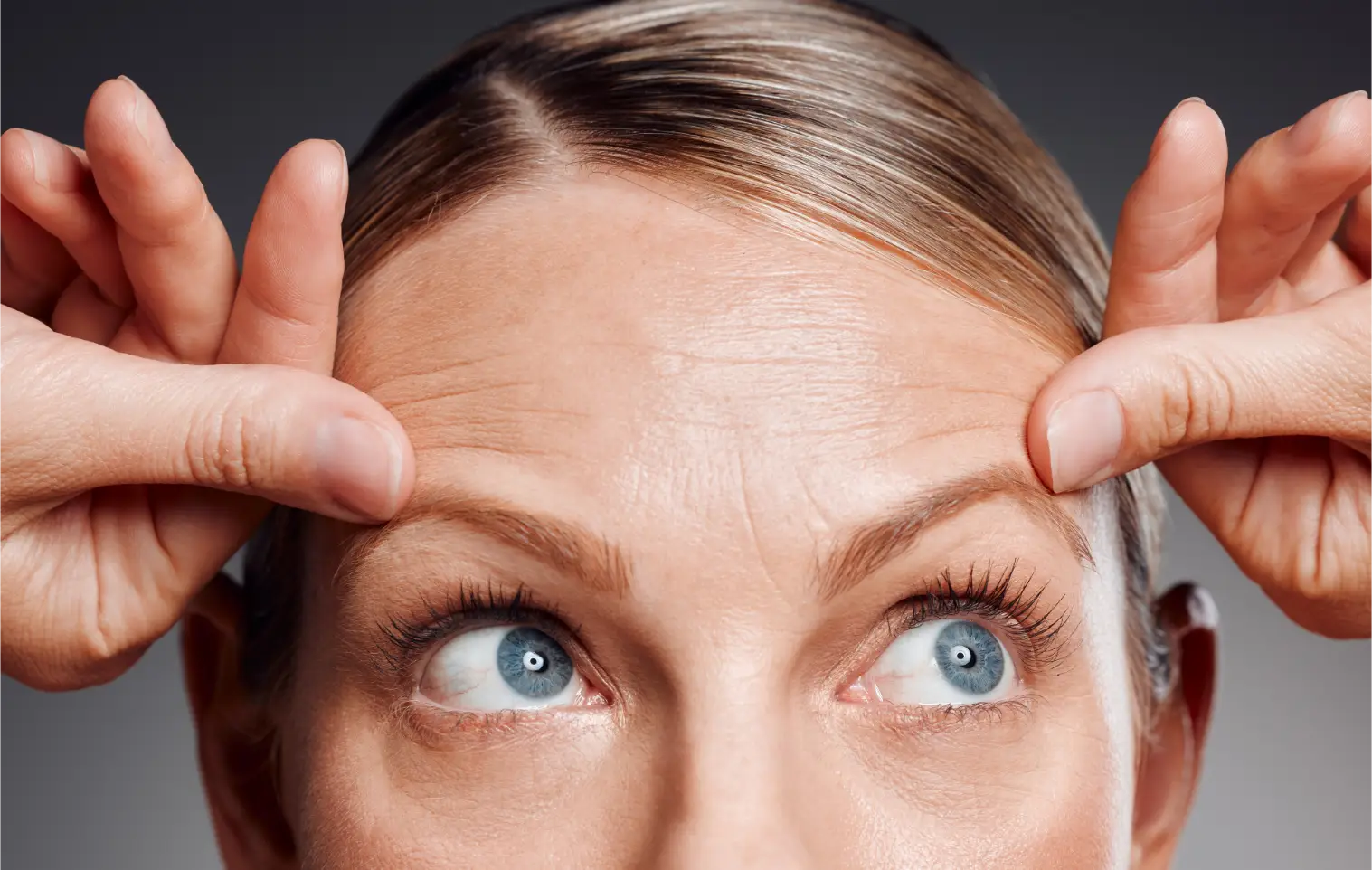Woman touching wrinkles on face