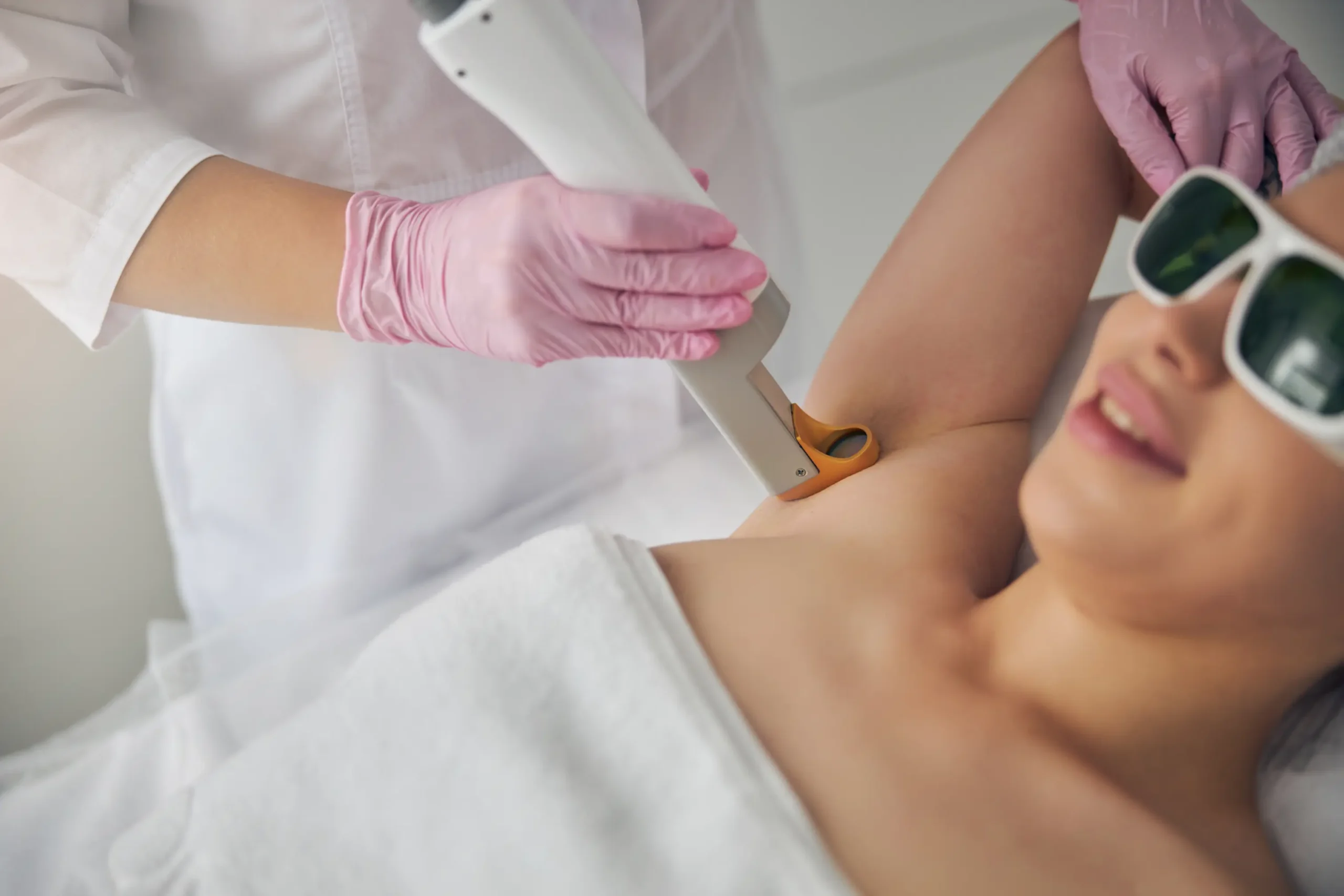 woman getting laser hair removal on underarm