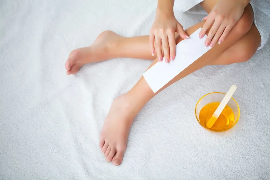 waxing stip on persons leg