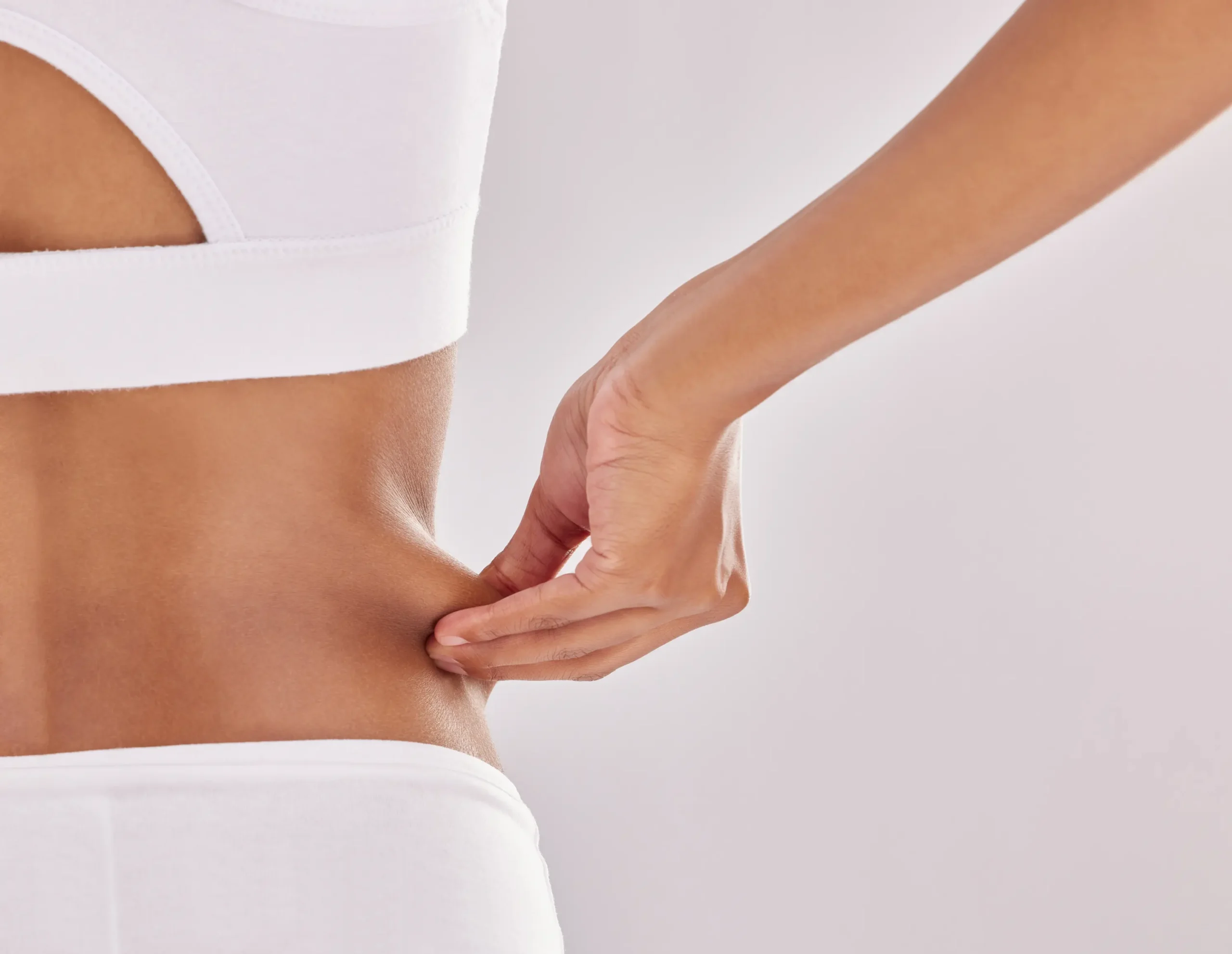woman holding stubborn fat