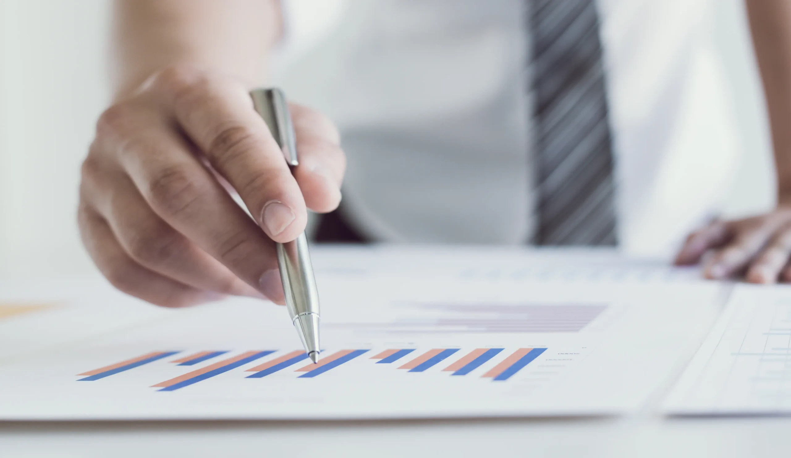 Person writing on graph