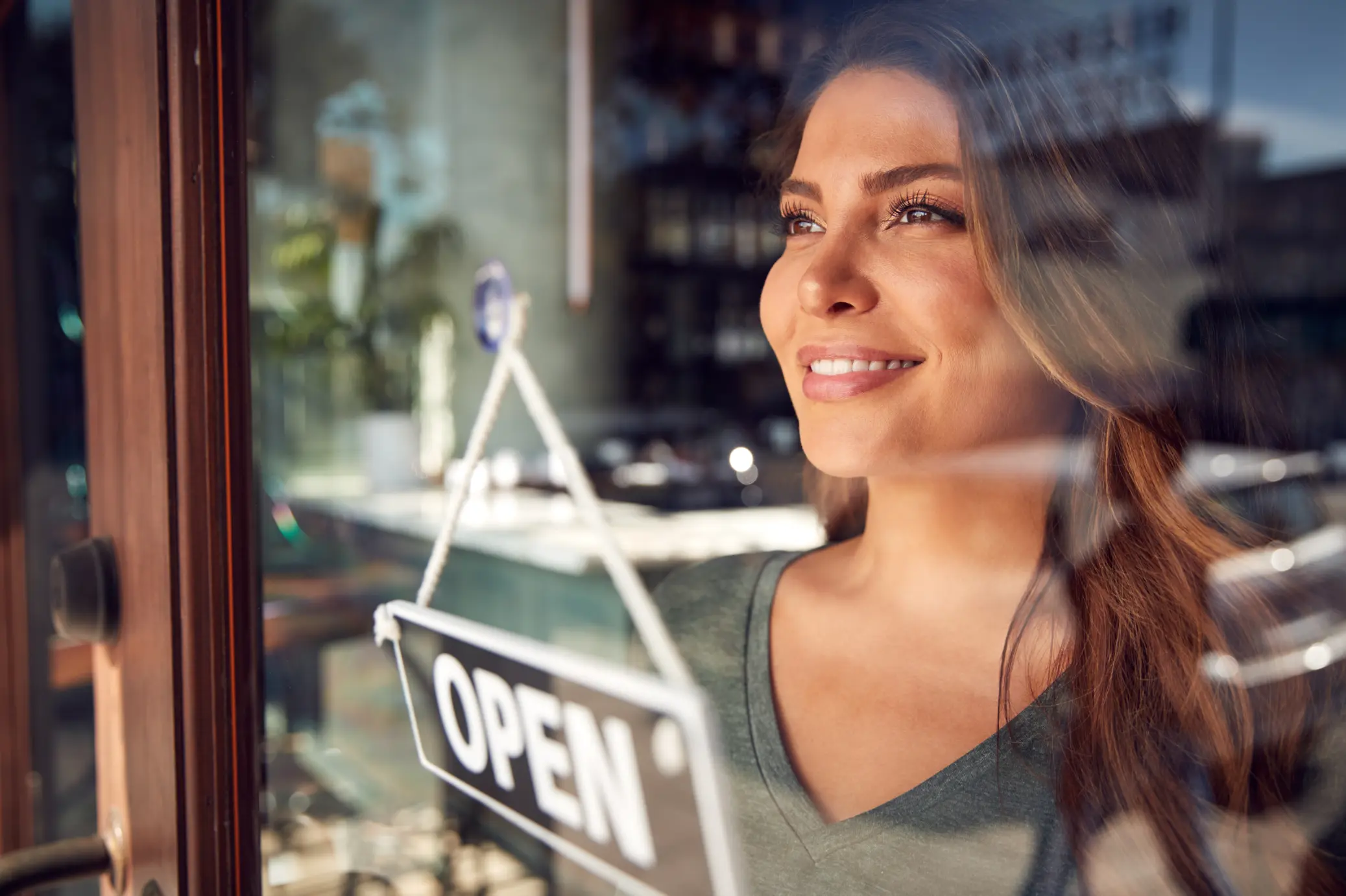 Woman standing infront of open sign