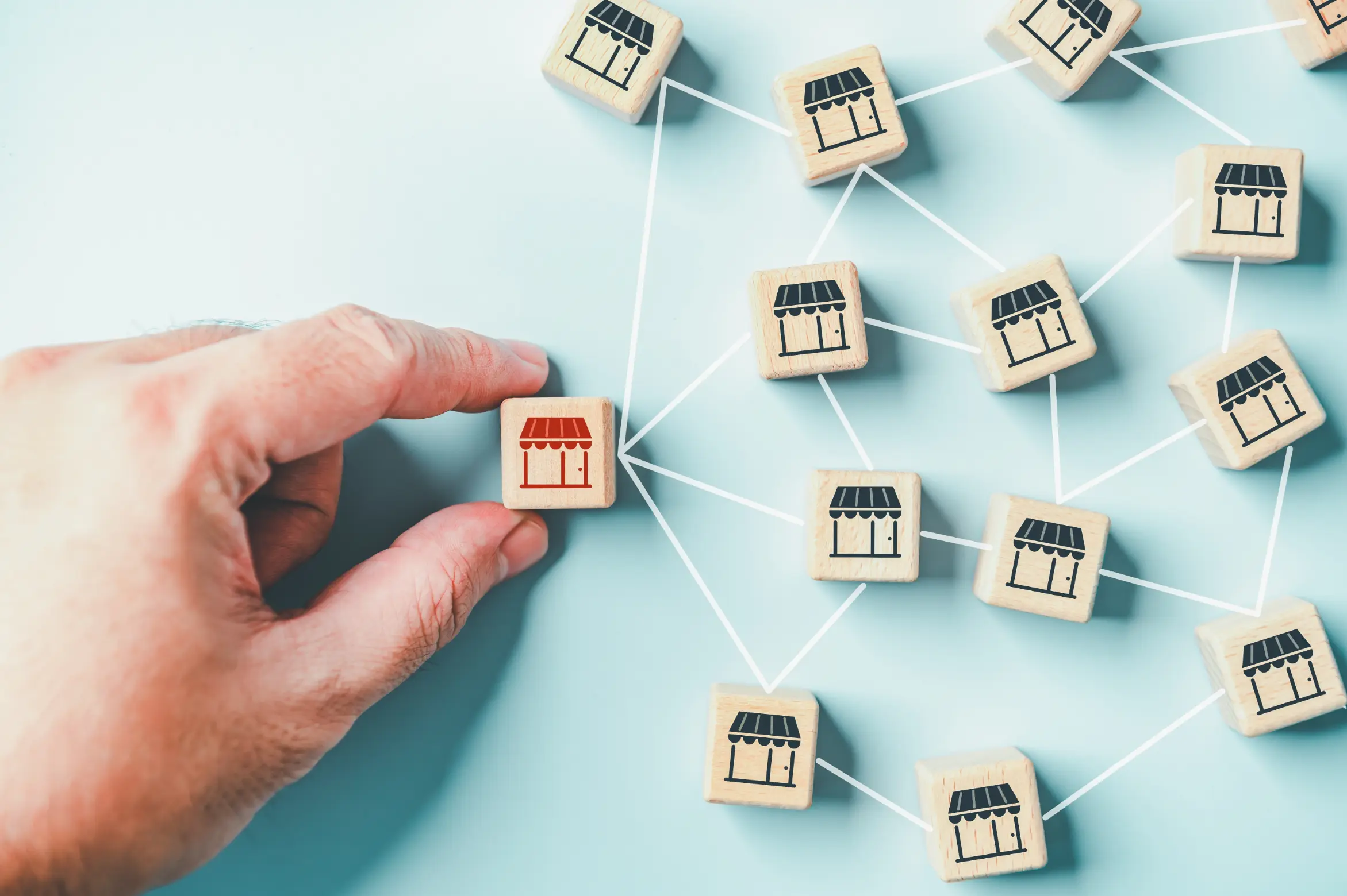 Person picking up franchise store block