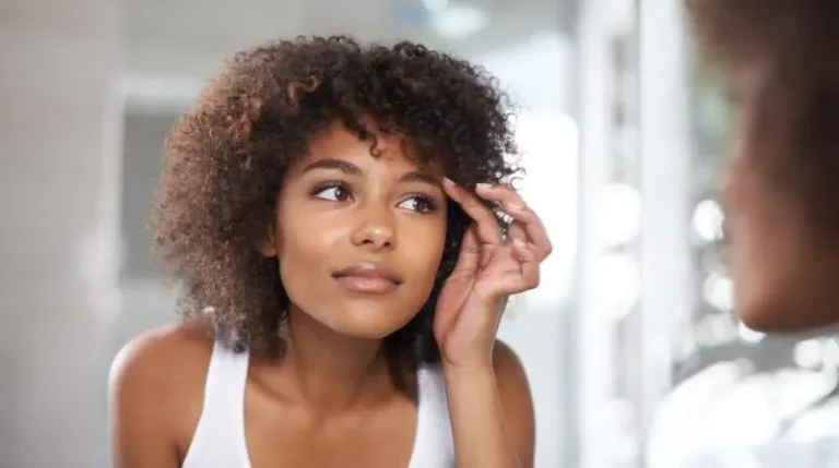 Woman touching her dark skin