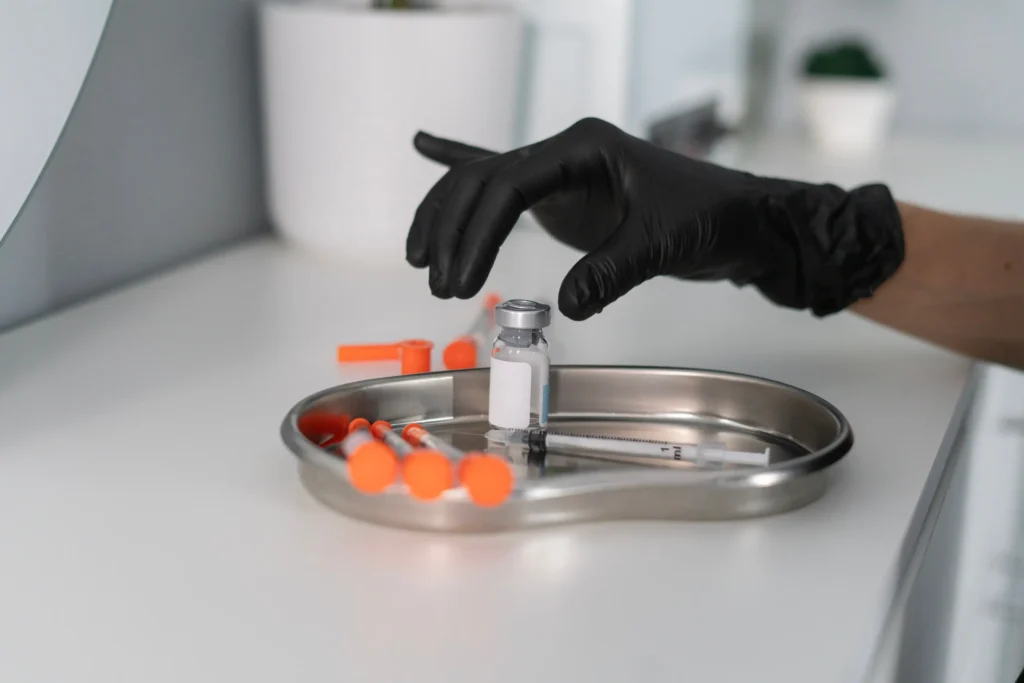 worker grabbing a injection bottle