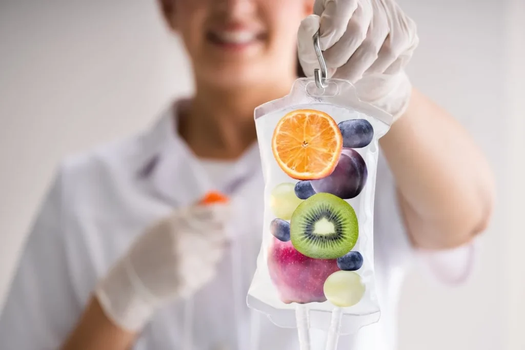 Worker holding Iv Drip with Fruits in the bag to represent the benefits