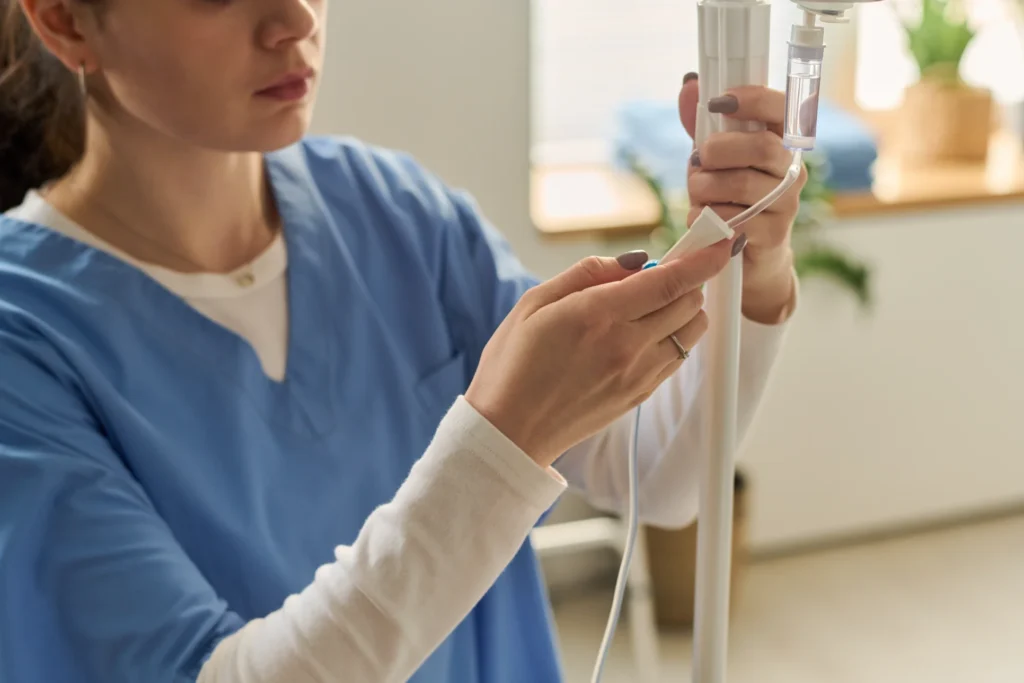 Worker setting up IV Drip
