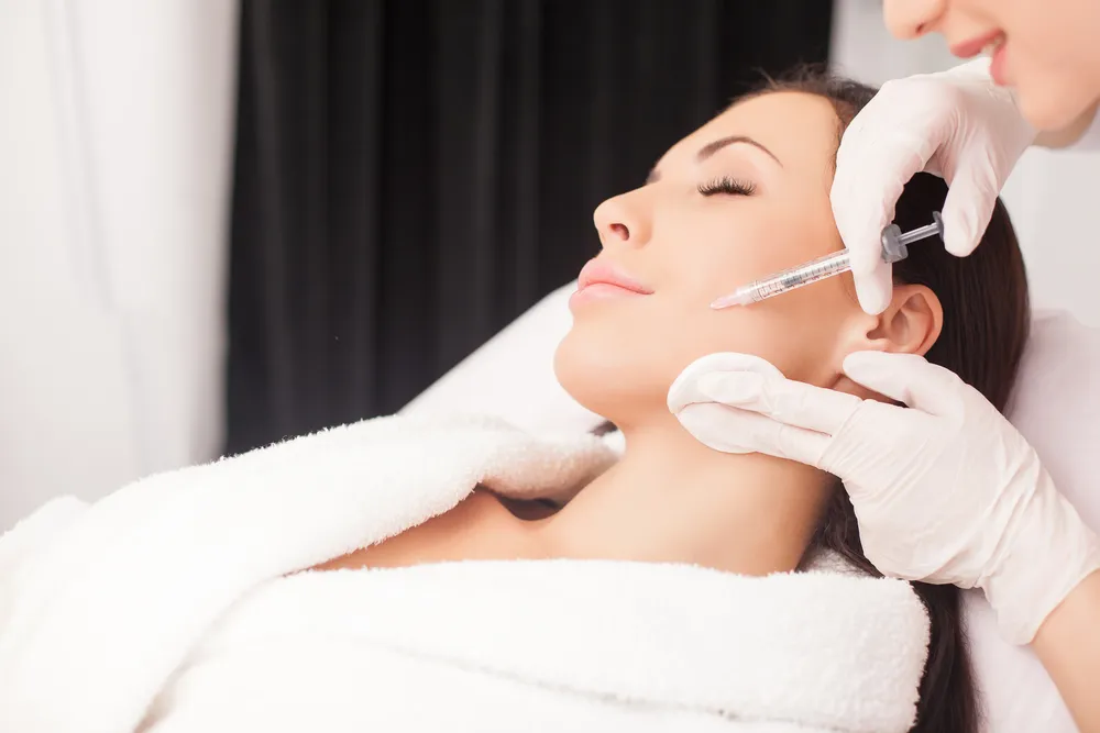 woman getting botox injection on face