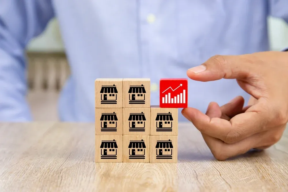 person placing block on their multi-unit franchise